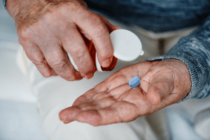 Elderly man takes pill